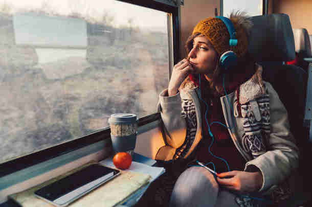Young woman in train looks out the window